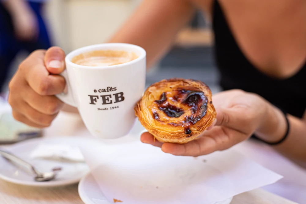 A lady holds a portuguese egg tart